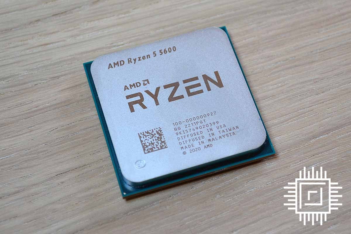 The AMD Ryzen-5 5600 processor sitting on a grey wooden table.
