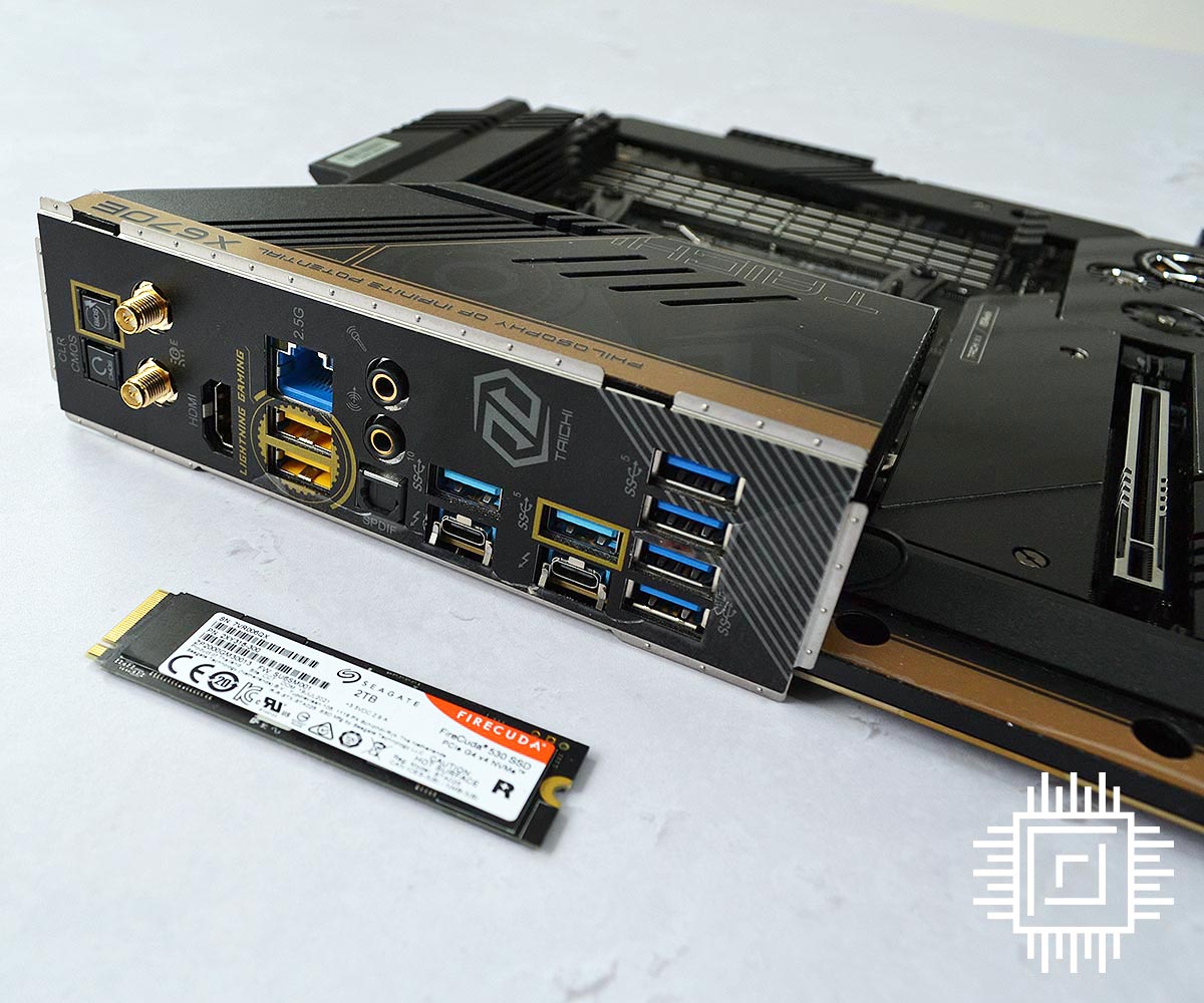 ASRock Z670E Taichi I/O ports with an M.2 SSD in front for scale.