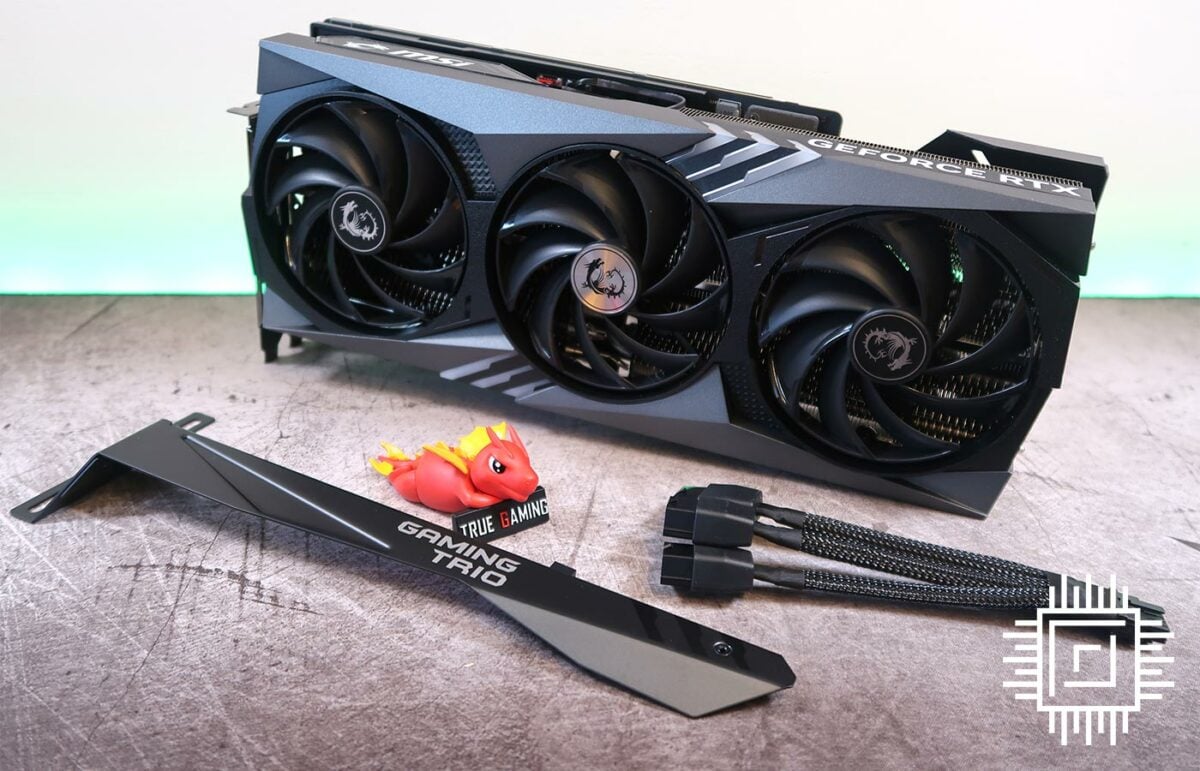 The MSI GeForce RTX 4090 Gaming X Trio graphics card, bundled with a cable, face plate, and dragon figure.