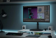 Cooler Master Tempest GP2711 Mini-LED gaming monitor on top of a desktop alongside PC peripherals