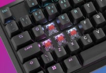 A Corsair K70 Core gaming keyboard with keycaps removed, revealing Corsair MLX Red mechanical switches.