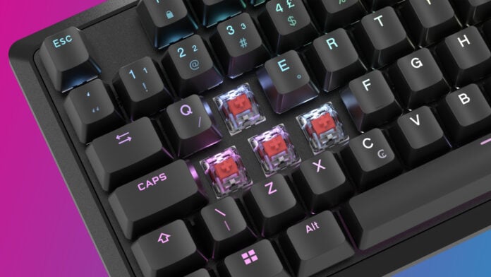 A Corsair K70 Core gaming keyboard with keycaps removed, revealing Corsair MLX Red mechanical switches.