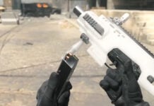 A Call of Duty Modern Warfare 3 Uzi held up as the player reloads ammo.