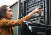 A woman inserting a WD Gold drive inside a WD Server Rack.