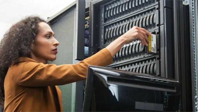 A woman inserting a WD Gold drive inside a WD Server Rack.