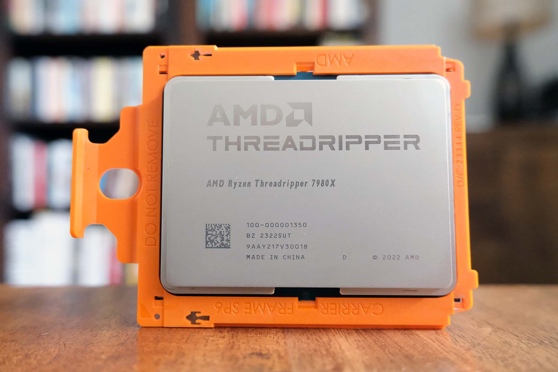 AMD Ryzen Threadripper 7980X CPU set against a blurred background.