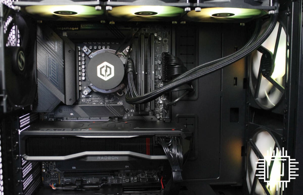 The inside of the Cyberpower Infinity X147 GRE gaming PC, with RGB fans and AIO cooler shining yellow and green.