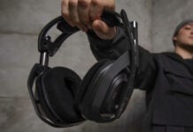 Logitech G ASTRO A50 X wireless gaming headset held by a person in black clothes.