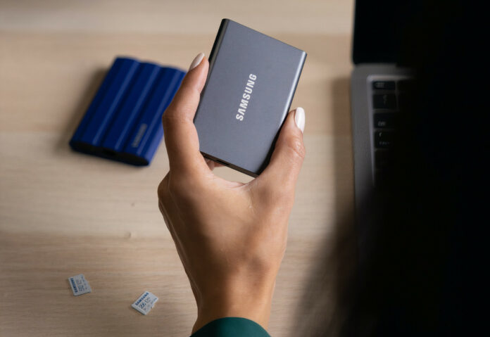 Promotional image by Samsung revealing a woman holding a Samsung Portable SSD.