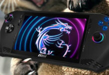 A cat playing with an MSI Claw gaming handheld.