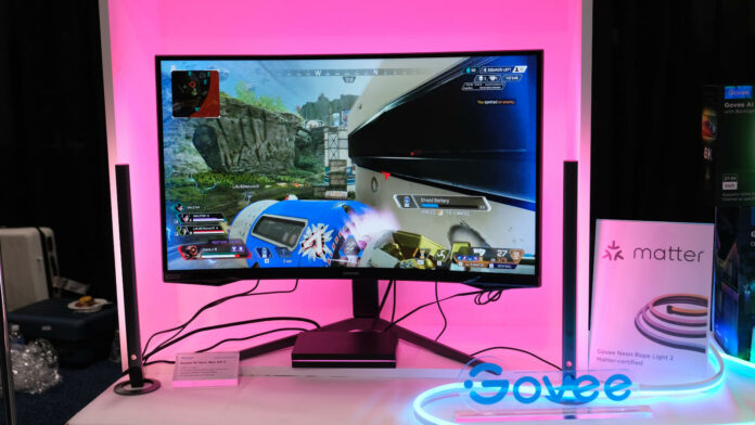 See Govee AI Sync Box Kit 2 in action, shining pink light behind the gaming monitor.