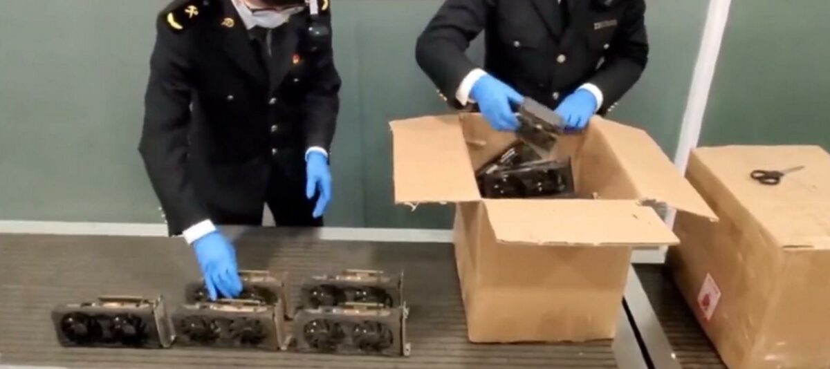 Chinese customs unpacking boxes filled with graphics cards.