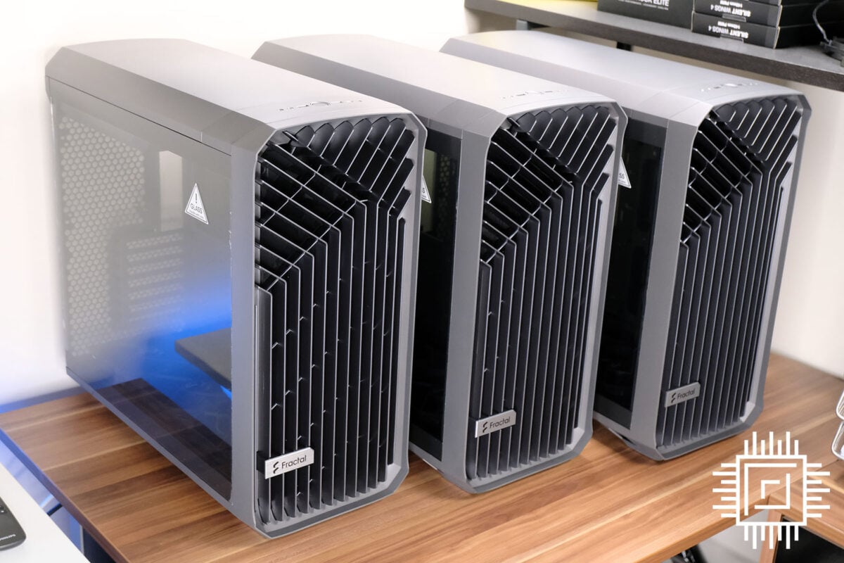 Three grey Fractal Torrent mid-tower cases lined up.