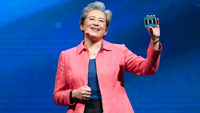 AMD CEO Dr. Lisa Su, holding a 5th Gen AMD EPYC CPU in her hand