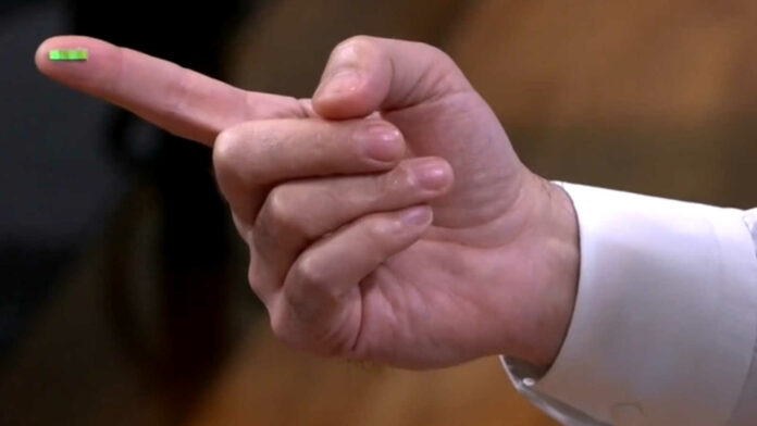 Western Digital QLC NAND chip atop the fingertip of a hand