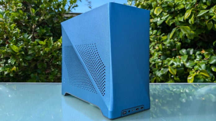 Fractal Design Era 2 atop a glass surface, against a background filled with green plants.