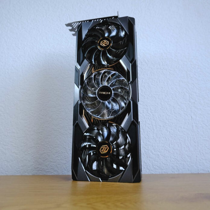 ASRock Radeon RX 9070 XT Taichi OC standing vertically on a wooden surface.