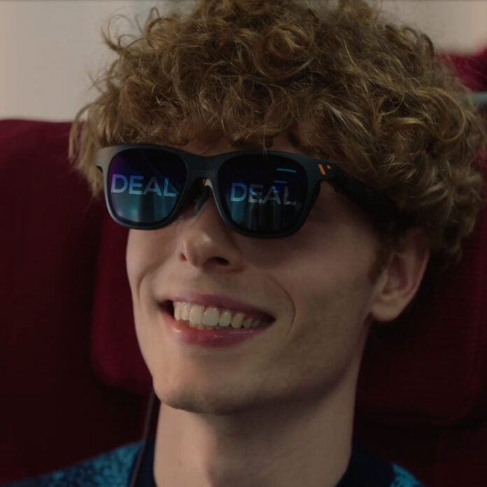 Man wearing Viture Pro XR glasses, smiling.