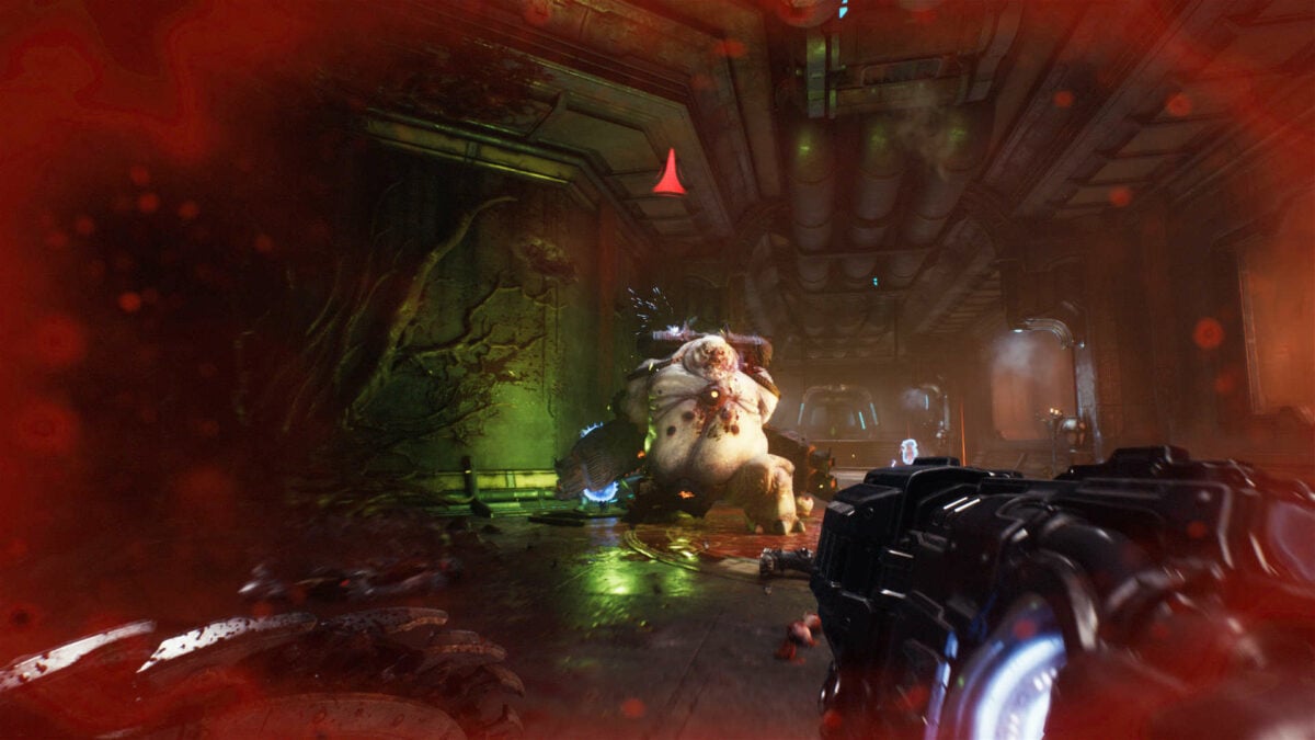 The Slayer fights a Mancubus with red blood surrounding the screen.