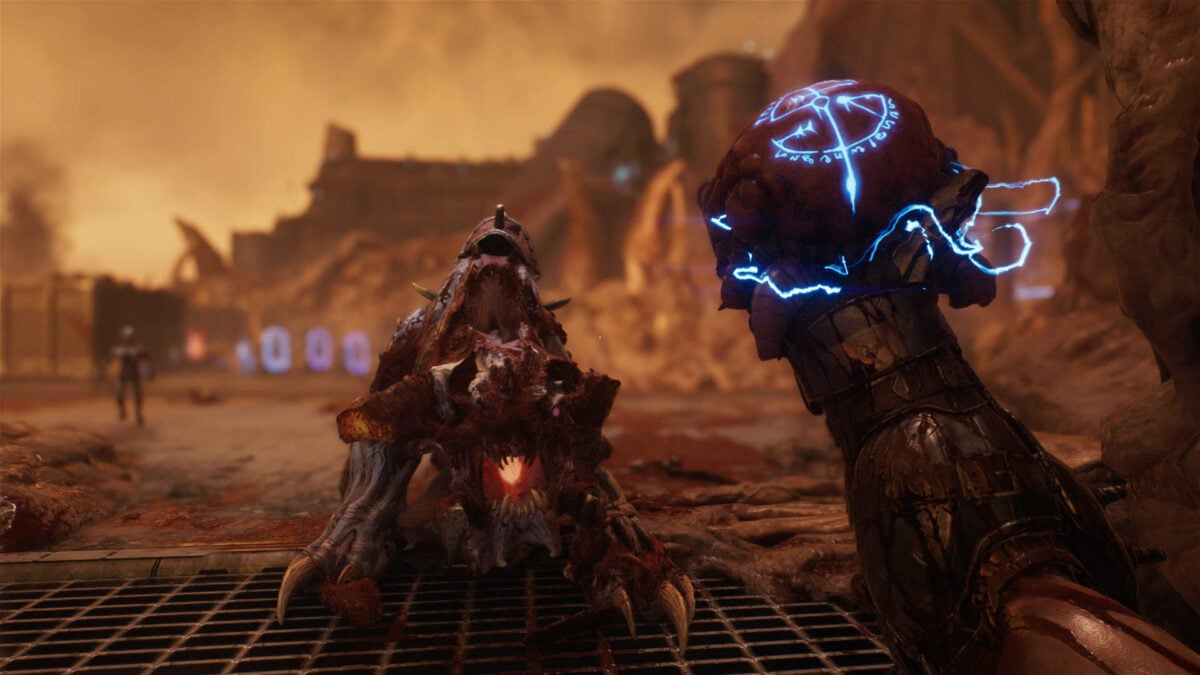 The Slayer holds a demon heart in his hand, about to crush it in Doom: The Dark Ages.