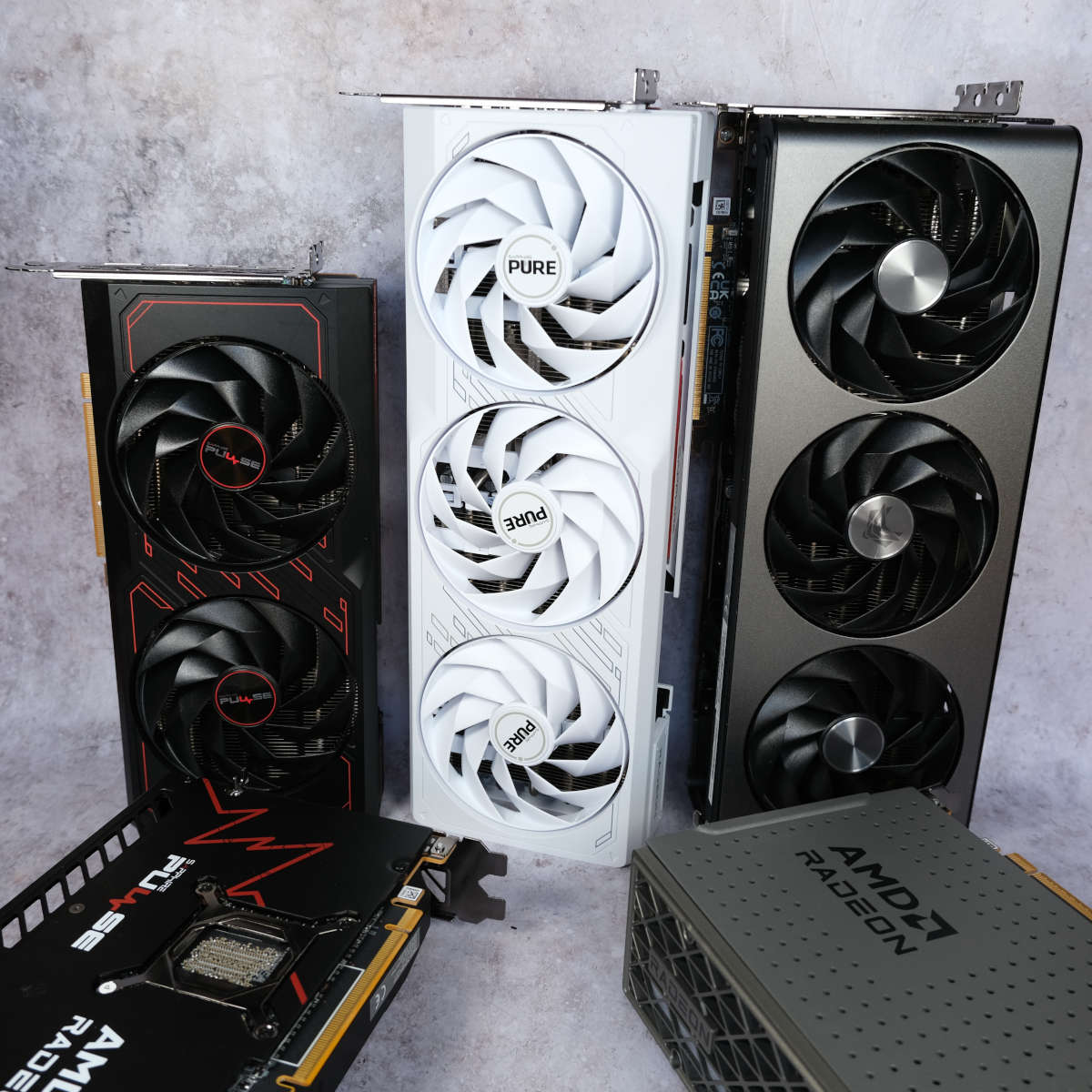 Three Sapphire Radeon graphics cards stand vertically, with two lying horizontally in front of them.