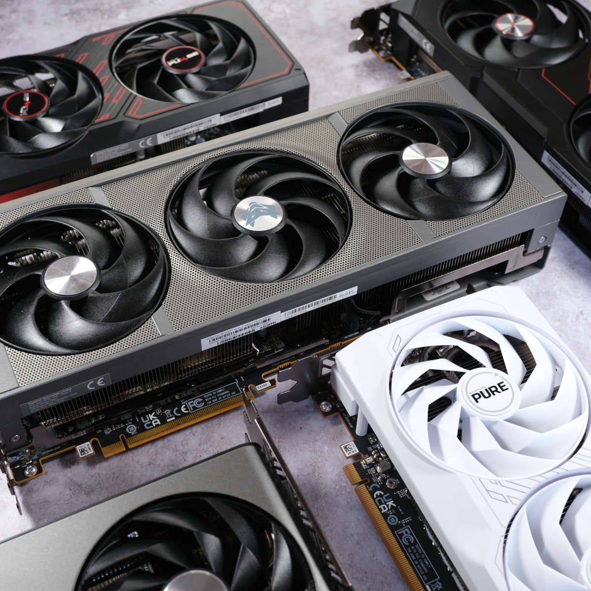 A close up of several Sapphire Radeon graphics cards loosely packed together, focussing on their fans.