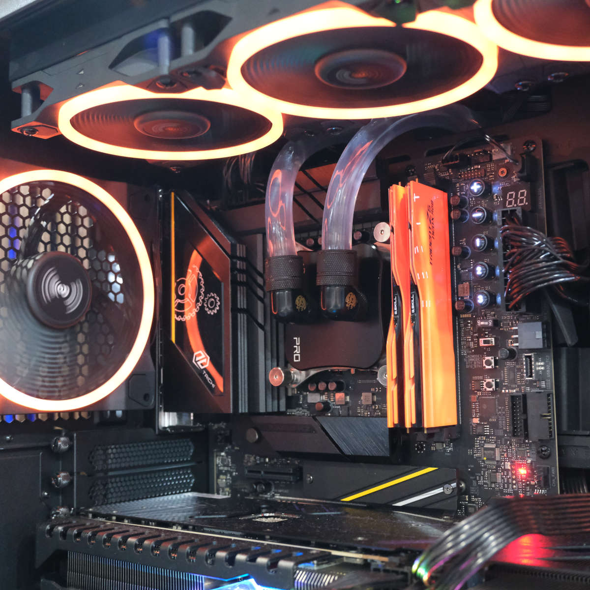 Orange G.Skill Trident Z5 NeoX RAM sticks in a system, with orange LEDs surrounding it from the fans.
