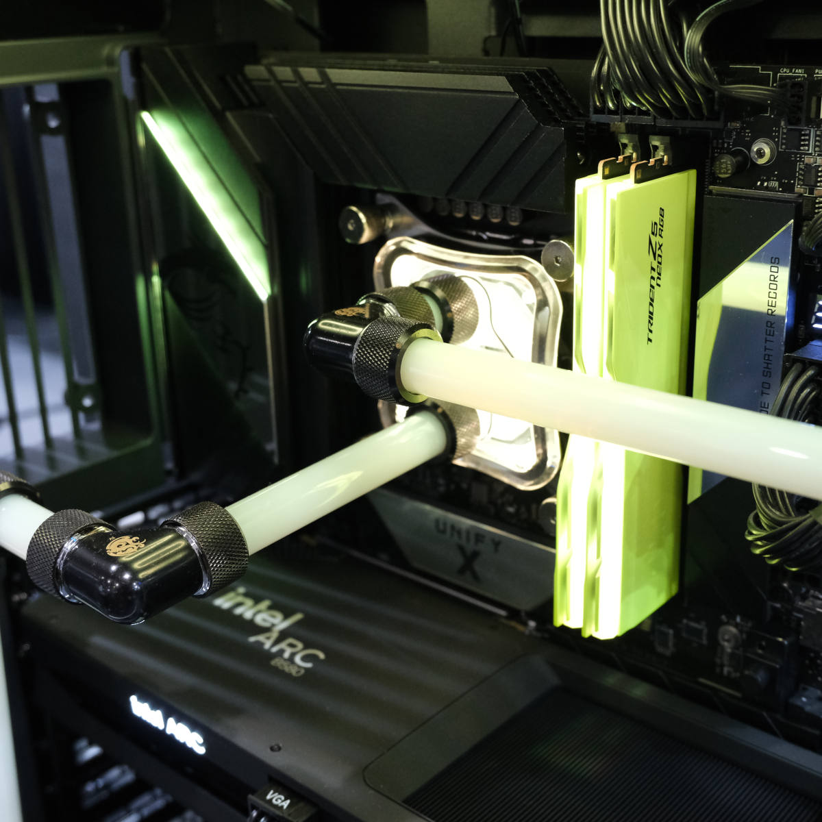 Yellow G.Skill Trident Z5 NeoX RAM sticks in a system, with yellow customer water cooling surrounding.