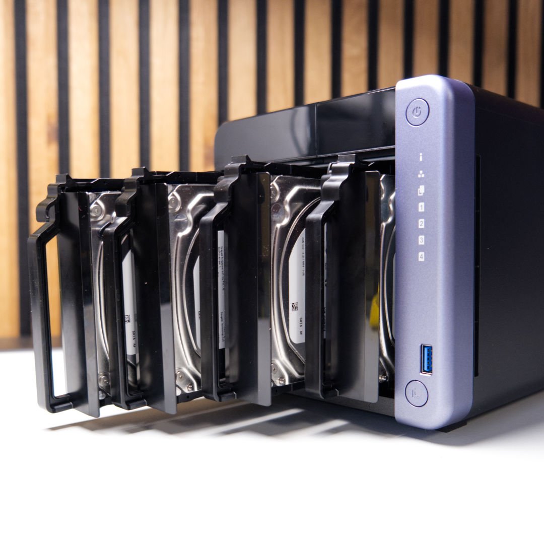 QNAP TS-432X hard drive bays filled.