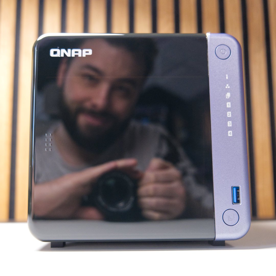 Damien Mason's reflection in QNAP TS-432X's shiny shell.