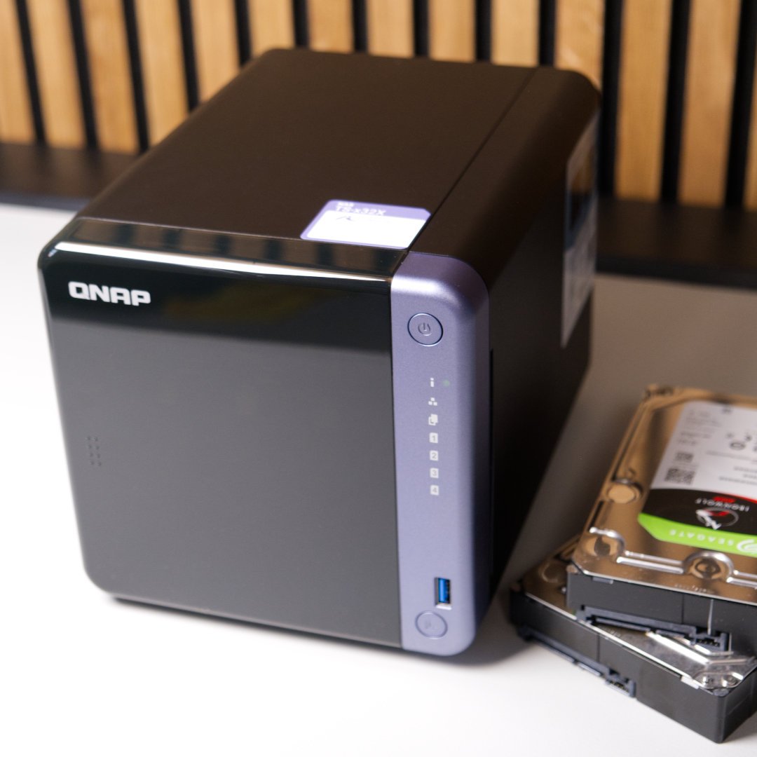 QNAP TS-432X next to Seagate hard drives.