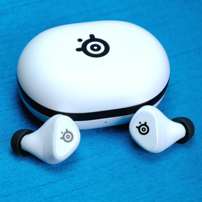 SteelSeries Arctis GameBuds sat outside their case against a blue background.