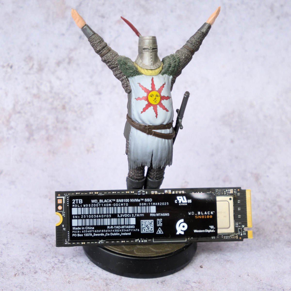 WD_Black SN8100 SSD, resting against an Amiibo of Solaire from Dark Souls.
