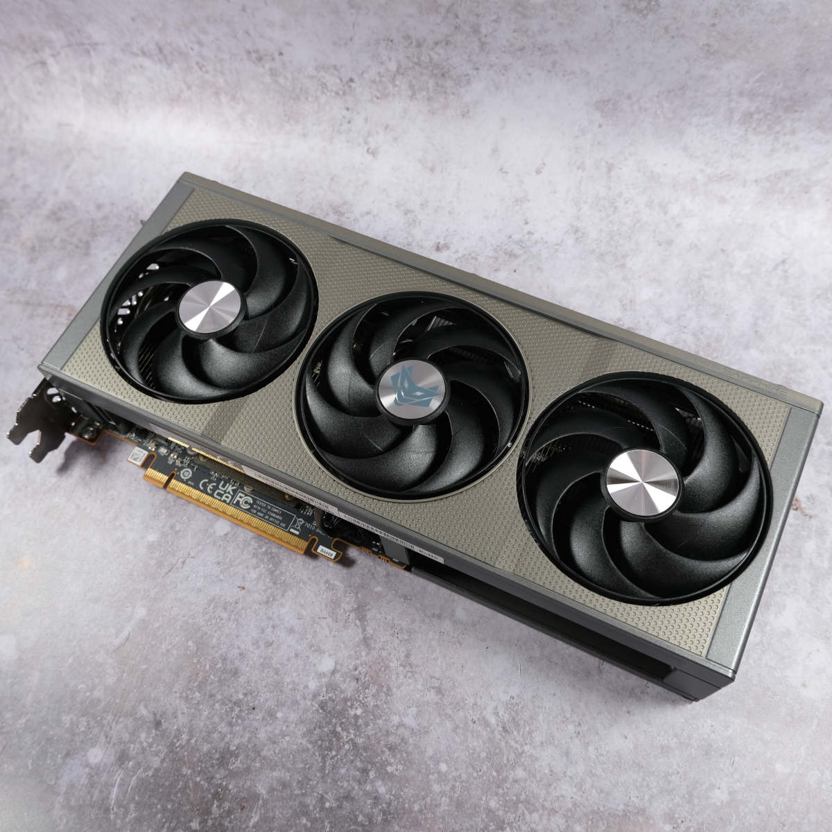 Sapphire Nitro+ Radeon RX 9060 XT 16GB lies on a pearlescent background, showcasing its frontplate.