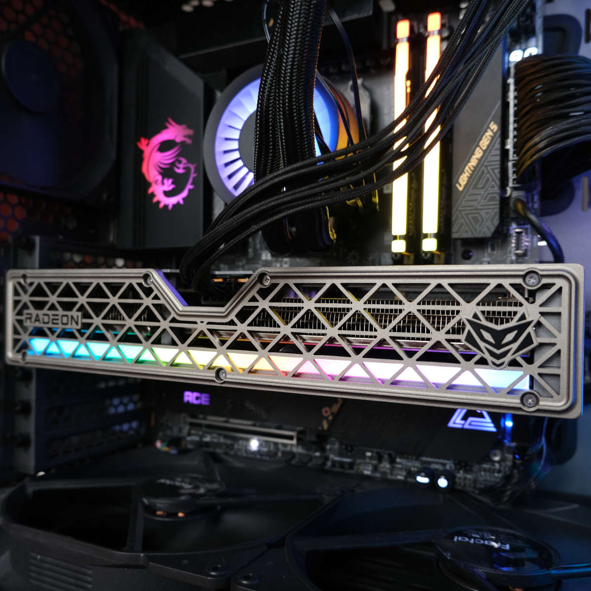 Close up of Sapphire Nitro+ Radeon RX 9060 XT 16GB powered on in side the Club386 test system, its ARB light bar glowing various colours.