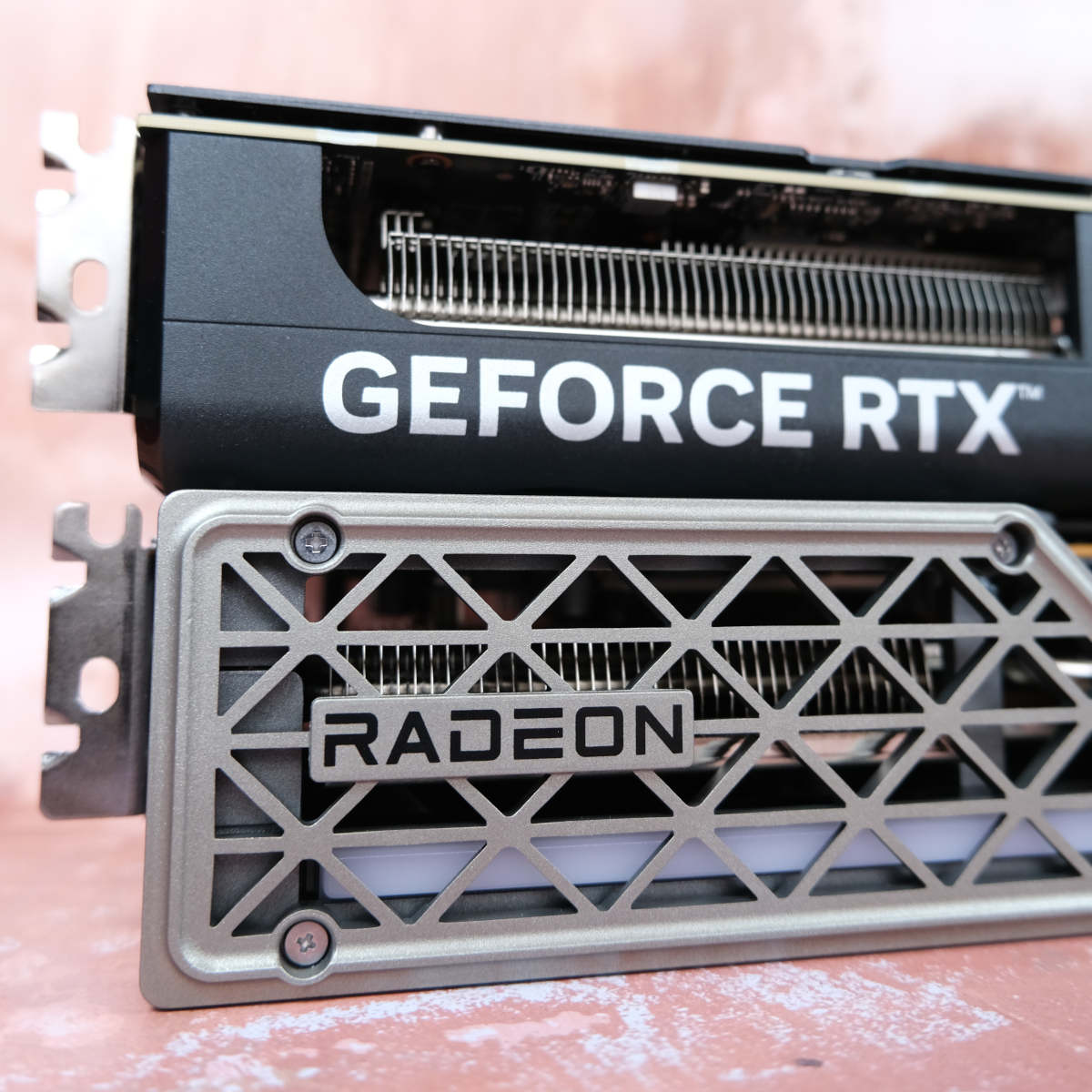 Asus GeForce RTX 5060 Ti 16GB Prime (top) laying horizontally on top of Sapphire Nitro+ Radeon RX 9060 XT 16GB (bottom).
