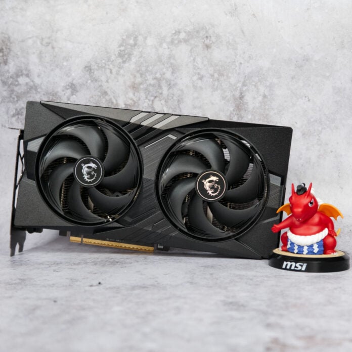 MSI GeForce RTX 5060 Gaming OC sitting upright in a horizontal orientation, with a small 'Lucky' dragon figure (right) next to it.