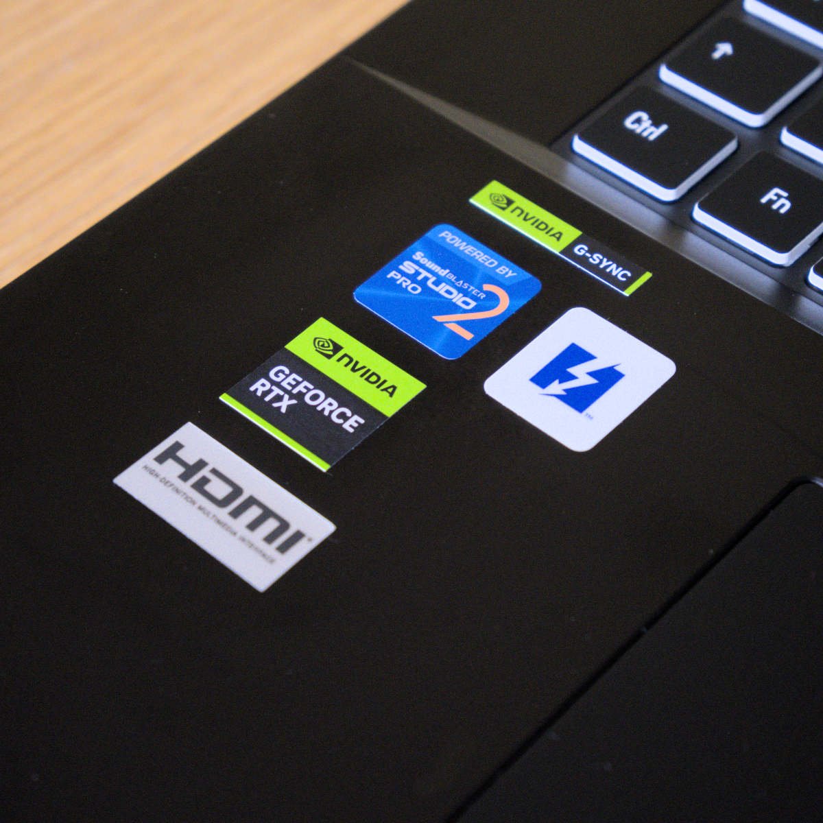 An array of stickers, including Creative, Nvidia, and Thunderbolt that describe the innards of PCSpecialist Recoil 18.