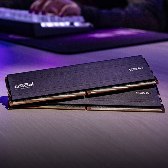 Crucial DDR5 Pro RAM sticks, lying on top of one another on a wooden surface.