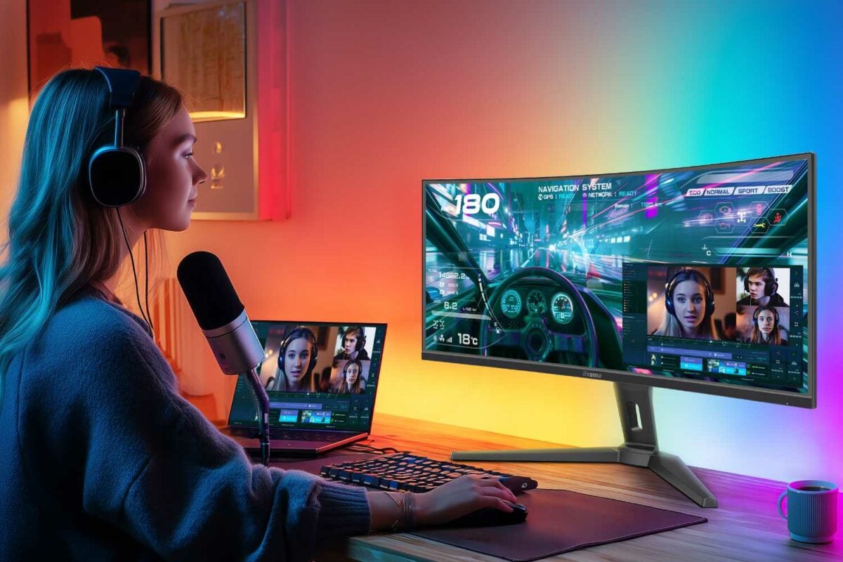 iiyama GCB3486WQSCP with RGB lighting glowing on the wall behind the monitor.