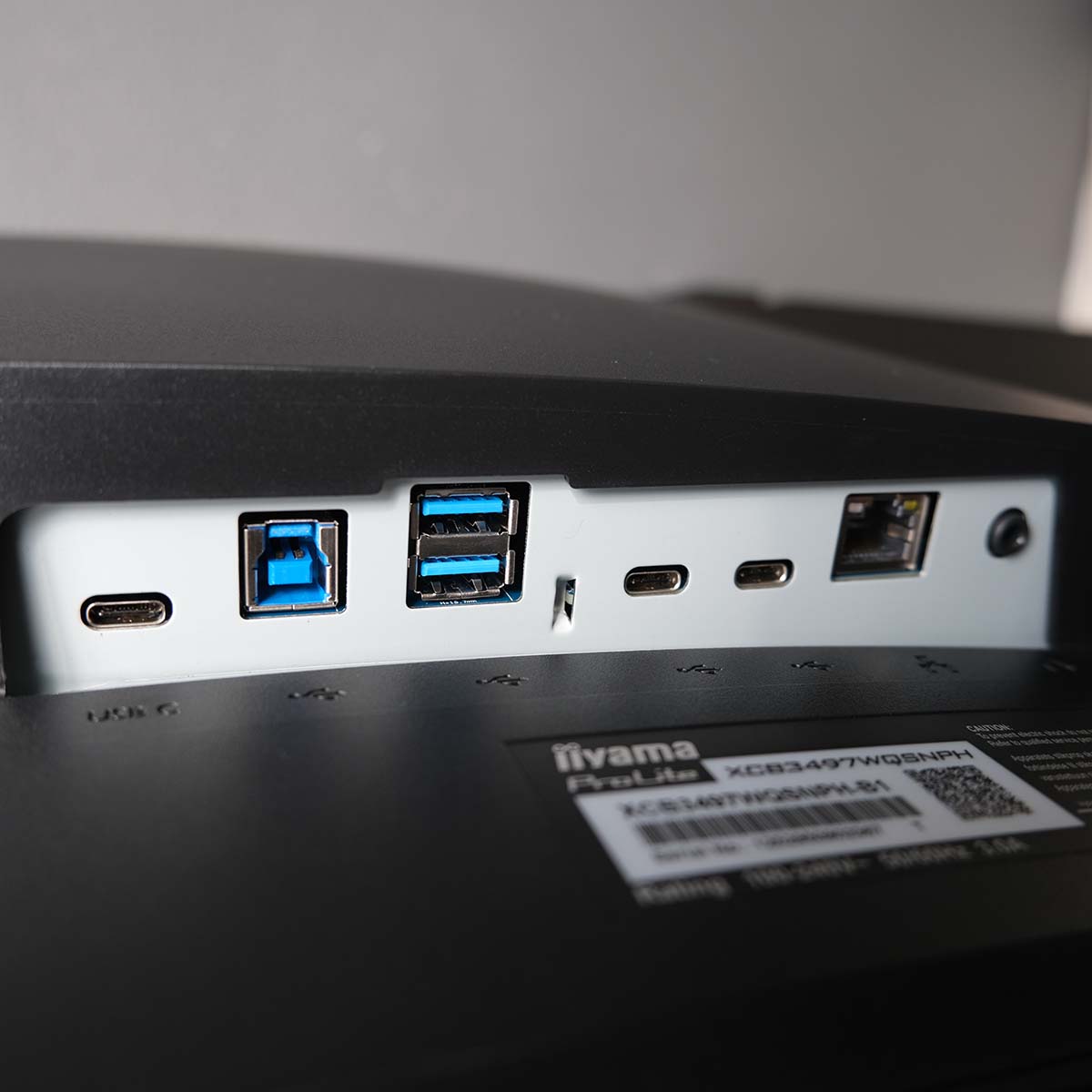 A close up of iiyama ProLite XCB3497WQSNPH-B1's connection options, including three USB-C, two USB-A, one USB-B, an RJ45 port, and a 3.5mm headphone output.