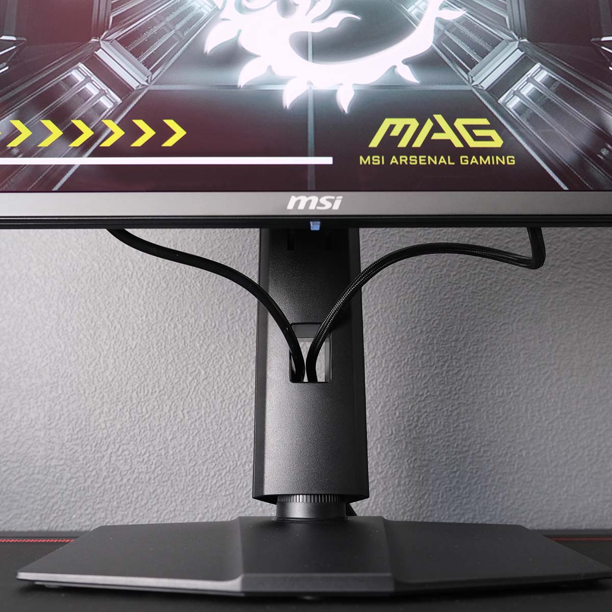 A close up of MSI MAG 272QP QD-OLED X50's stand, focussing on its cable grommet.