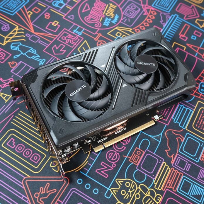 Gigabyte GeForce RTX 5050 Windforce OC graphics card lies flat, at a tilting angle, its frontplate facing the camera.