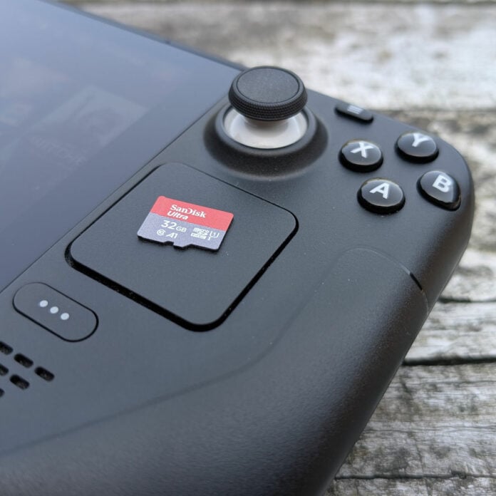 A SanDisk microSD card rests on a Steam Deck touch pad.