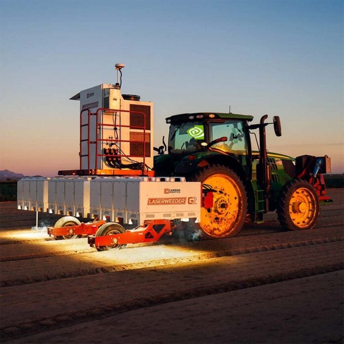 A tractor pulling a LaserWeeder G2, with the farmer's head replaced by an Nvidia logo.