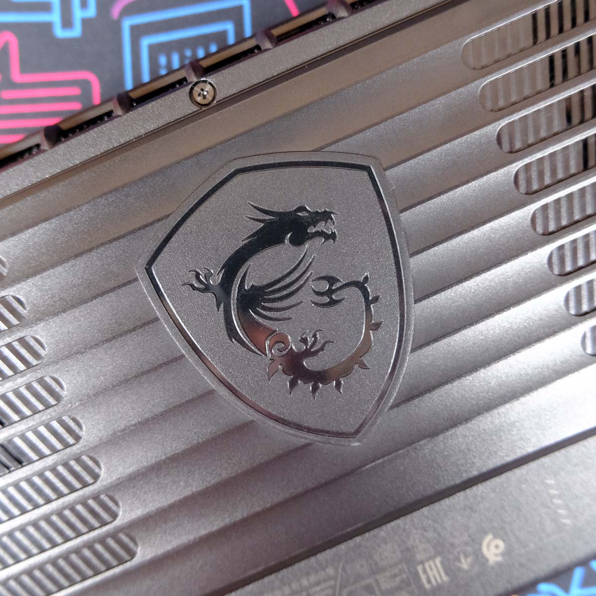 A close up of the MSI dragon badge on the rear of Claw 8 AI+.