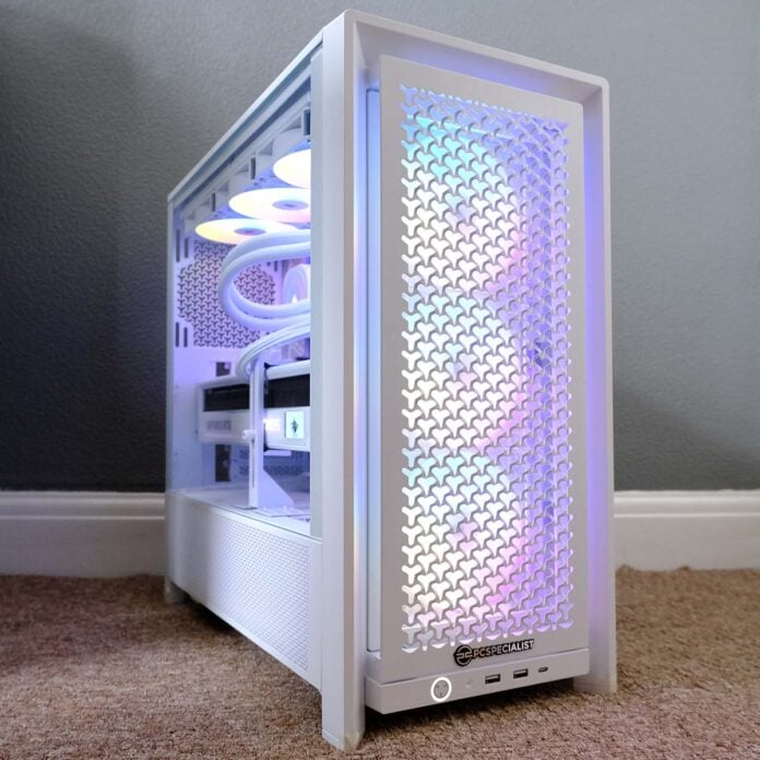 A front-side view of PCSpecialist Luna Recon Master, the system's ARGB fans shining brightly in a rainbow pattern.