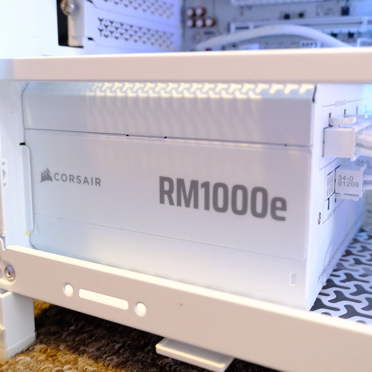 A close up of Corsair RM1000e power supply, inside PCSpecialist Luna Recon Master.
