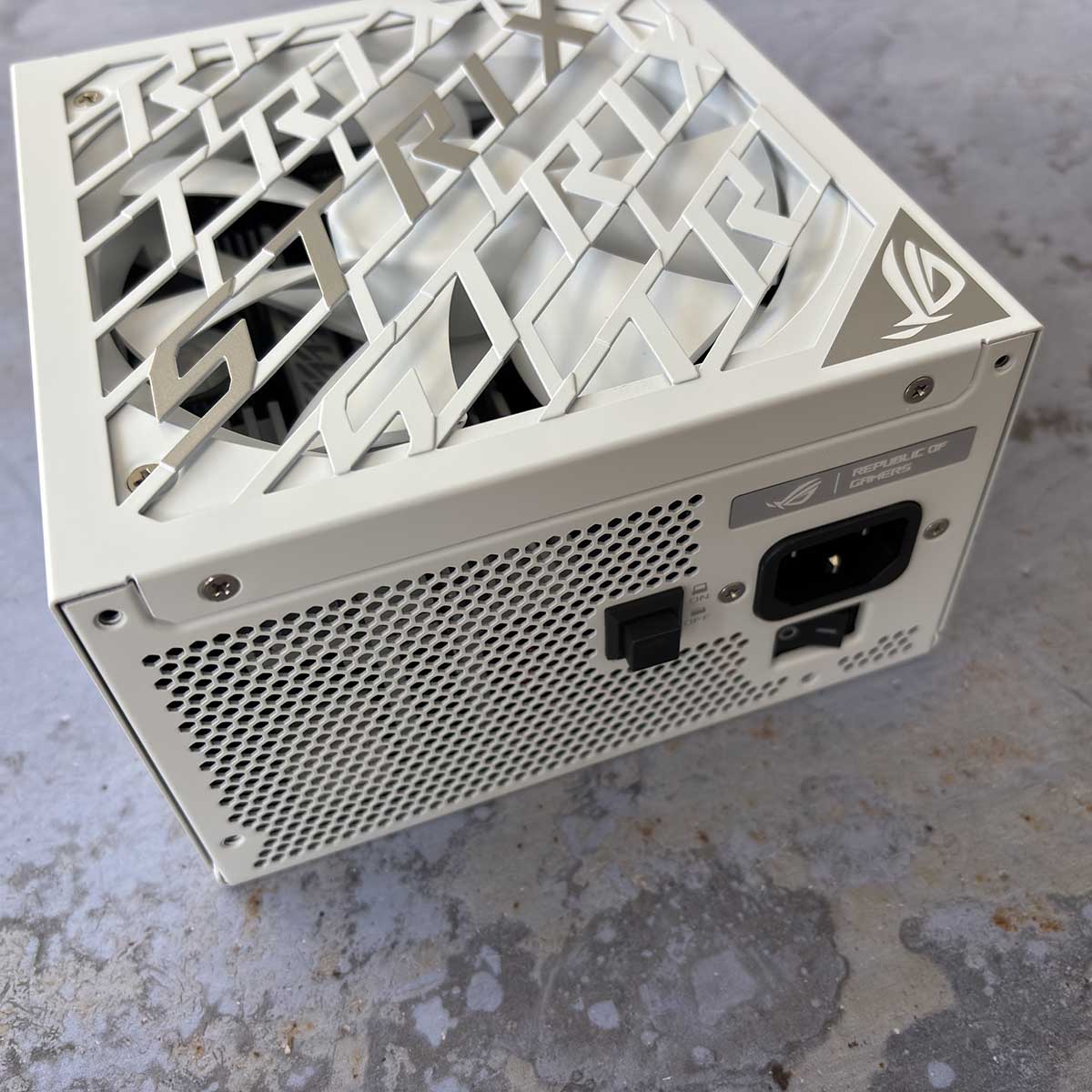 Picture of Asus ROG Strix Platinum 1,00W PSU showing button side.