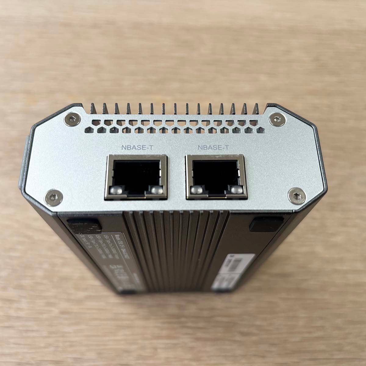 A picture of the QNAP USB to Ethernet adapter with ports showing.